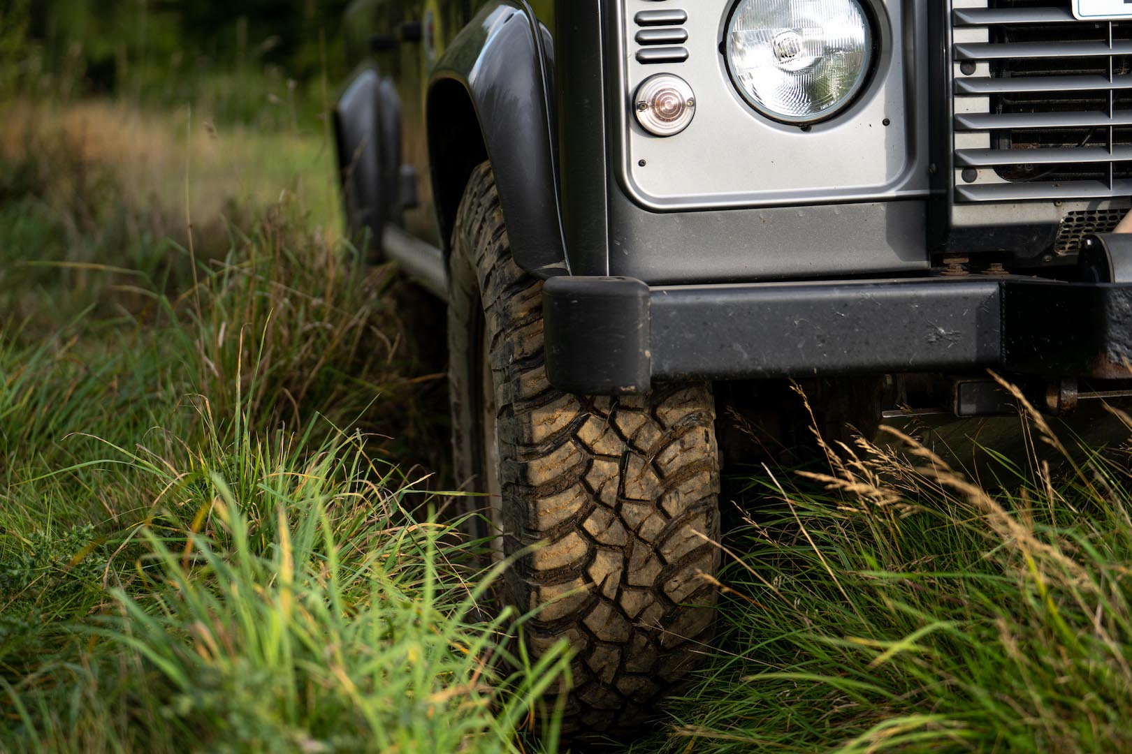 Close up of Land Rover Defender wheel climbing steep hill