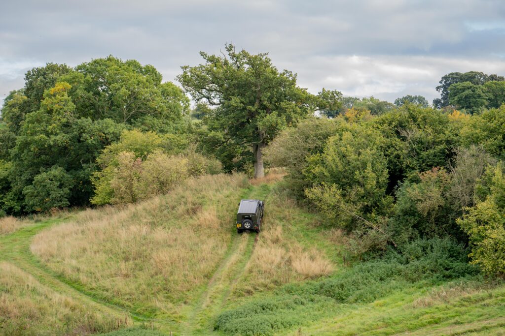 Off road vehicle climbing steep hill in the distance